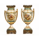 A pair of continental ceramic urns of neoclassical design, with spelter gilt mounts,