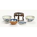 Three Chinese blue and white bowls, and a hardwood stand. Largest diameter 14.5 cm.