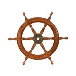 A teak ships wheel. Width 64 cm.