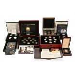 A collection of cased sets of coins,