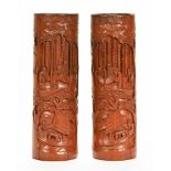 A pair of 20th century Chinese bamboo brush pots, carved in relief with trees, figures and boats.