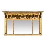 A Regency giltwood and gesso overmantel mirror, with Egyptian style supports.