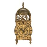 A lantern type mantel clock. Height 24 cm, width 9 cm, depth 9 cm.
