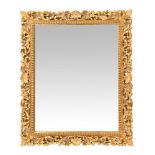 A late 20th century rectangular gilt framed mirror, with bevelled edge and shell decoration.