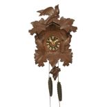 A 20th century stained frame Black Forest cuckoo wall clock, with bird and applique decoration,