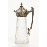 A silver plated and glass claret jug, with embossed decoration and figural spout. 29 cm high.