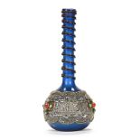A Persian blue glass vase with silver coloured metal overlay and cabochons, pontil mark to base.