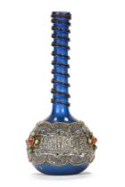 A Persian blue glass vase with silver coloured metal overlay and cabochons, pontil mark to base.