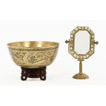 A Chinese bronze bowl on stand, together with a brass framed mirror. Bowl diameter 30 cm.