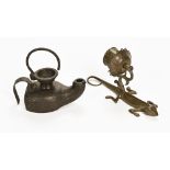 An Indian brass candle sconce. Height 22 cm and an antique iron oil lamp.
