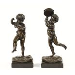 A pair of green patinated bronze Putto figures, Victorian,