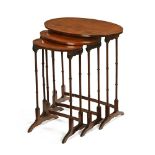 A nest of three mahogany oval occasional tables. Tallest 70 cm high.