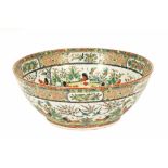 A 20th century Cantonese style bowl, decorated with landscape hen and bird designs.