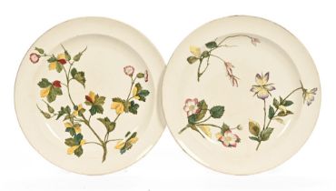 A pair of Wedgwood hand painted foliate patterned plates, with impressed marks. Diameter 25.5 cm.