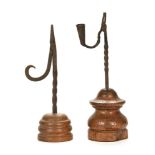 Two reed light holders, first possibly late 18th century with twisted shaft and turned carved base,