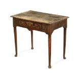 An 18th century rectangular oak side table, with carved frieze, central drawer and four pad feet.