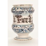 An 18th century delft ware drug jar, inscribed B Lucatell. 19 cm high. (see illustration).