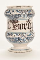 An 18th century delft ware drug jar, inscribed B Lucatell. 19 cm high. (see illustration).