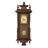 A late Victorian mahogany and stained frame Vienna wall clock,