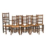 A set of seven 19th century ash and elm rush seated dining chairs,