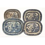 A collection of four blue and white Willow pattern platters. Largest 44 x 35 cm.