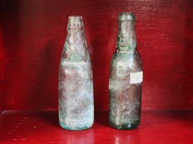 Two narrow neck glass brewery bottles by Robinson's, Derwent Works, Keswick and E.H.