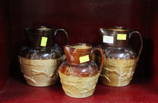 Three salt glazed pottery jugs decorated with windmills and countryside scenes