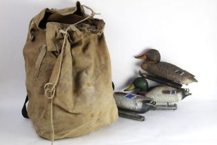 A rucksack containing nine full bodied duck decoys.