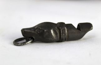 A Victorian pewter whistle in the form of a dogs head with hanging loop,