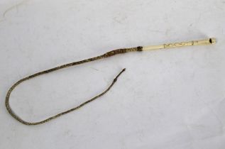 A bone whip with combined whistle, length excluding whip section 21 cm.