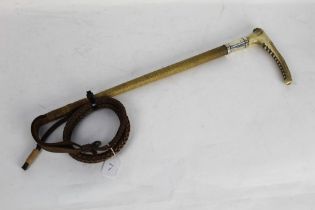 A riding hunting whip with red stag antler handle and silver collar marked WSC,
