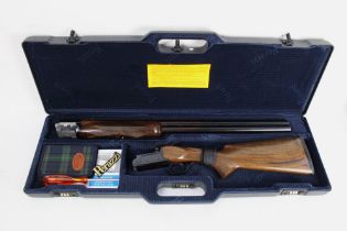 A Perazzi MX12, 12 bore over/under shotgun, with 27 1/2" barrels, half and quarter choke,