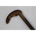 A walking stick with carved horn handle in the form of a trout, signed with a cross,