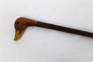 A walking stick with carved duck handle,