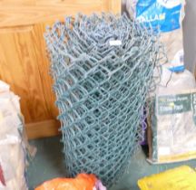 Roll of green metal chain link fencing