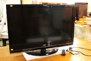 LG flatscreen TV with remote control,