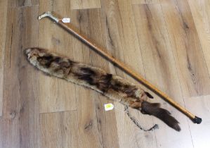 Fur stole and an antler topped walking stick