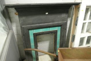 Metal fire surround with green tiled inlay, to include hood, grate,