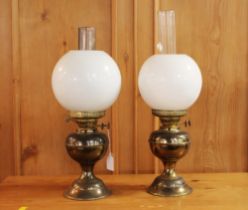 Two vintage oil lamps with shades and chimneys