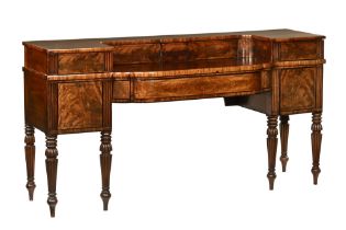 A large Regency William IV mahogany breakfront sideboard, central upper section with sliding doors,