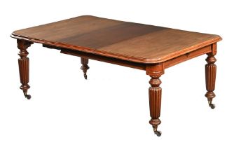 A late Victorian wind out dining table, on heavy fluted legs.