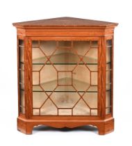 A 20th century period style satinwood corner floor display cabinet,