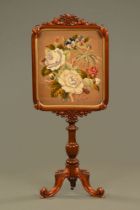 A Victorian mahogany pole screen, with woolwork tapestry panel,