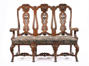 An early 20th century walnut framed triple chair back sofa,