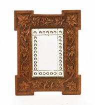 An Arts & Crafts oak framed mirror, the frame with carved ivy decoration. Frame size 38.5 cm x 30.