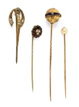 A collection of four antique stick pins.