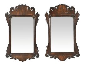 A pair of late 18th/early 19th century fret carved wall mirrors, with moulded slips.