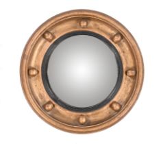 An early 20th century convex wall mirror, in the Regency style,
