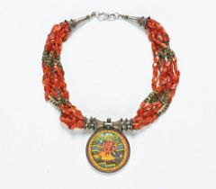 A Tibetan amber necklace, with miniature painting of Ganesh. Diameter 5 cm.