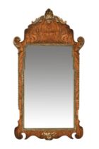 An early Georgian style walnut and gilt wall mirror. 79 cm high.